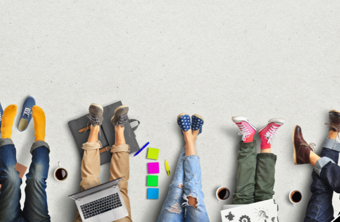 Persone con stili diversi rappresentati da scarpe e abbigliamento differenti, simbolo di collaborazione nel lavoro oltre il talento individuale